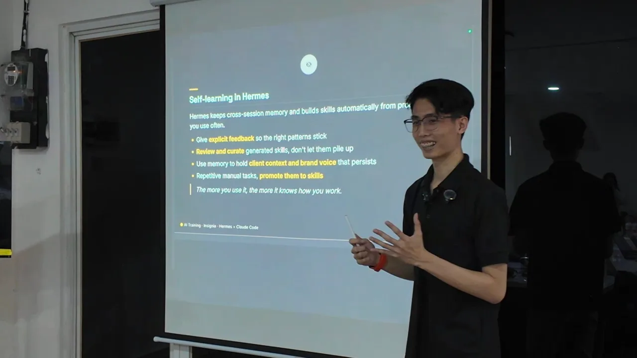Aurelius Ivan Wijaya delivering corporate AI training at Insignia, presenting a slide on self-learning agents with Hermes and Claude Code